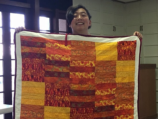 Lily and her completed quilt.