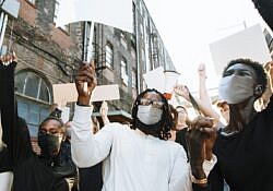 Diverse people wearing mask protesting during COVID-19 pandemic